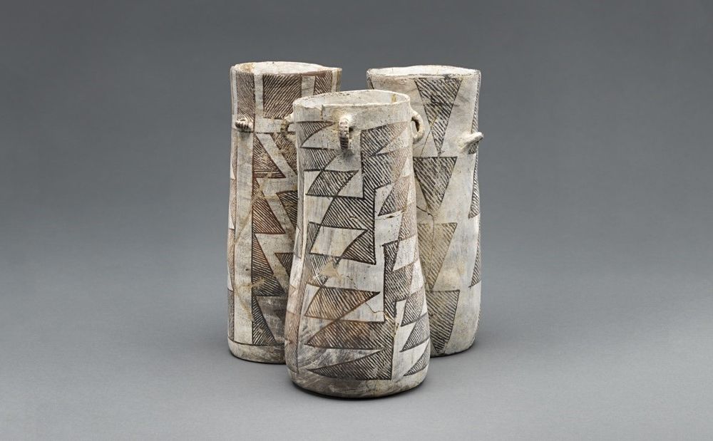 Tall spouted ceramic pots used for frothing and serving cacao drinks during Mesoamerican sacred rituals