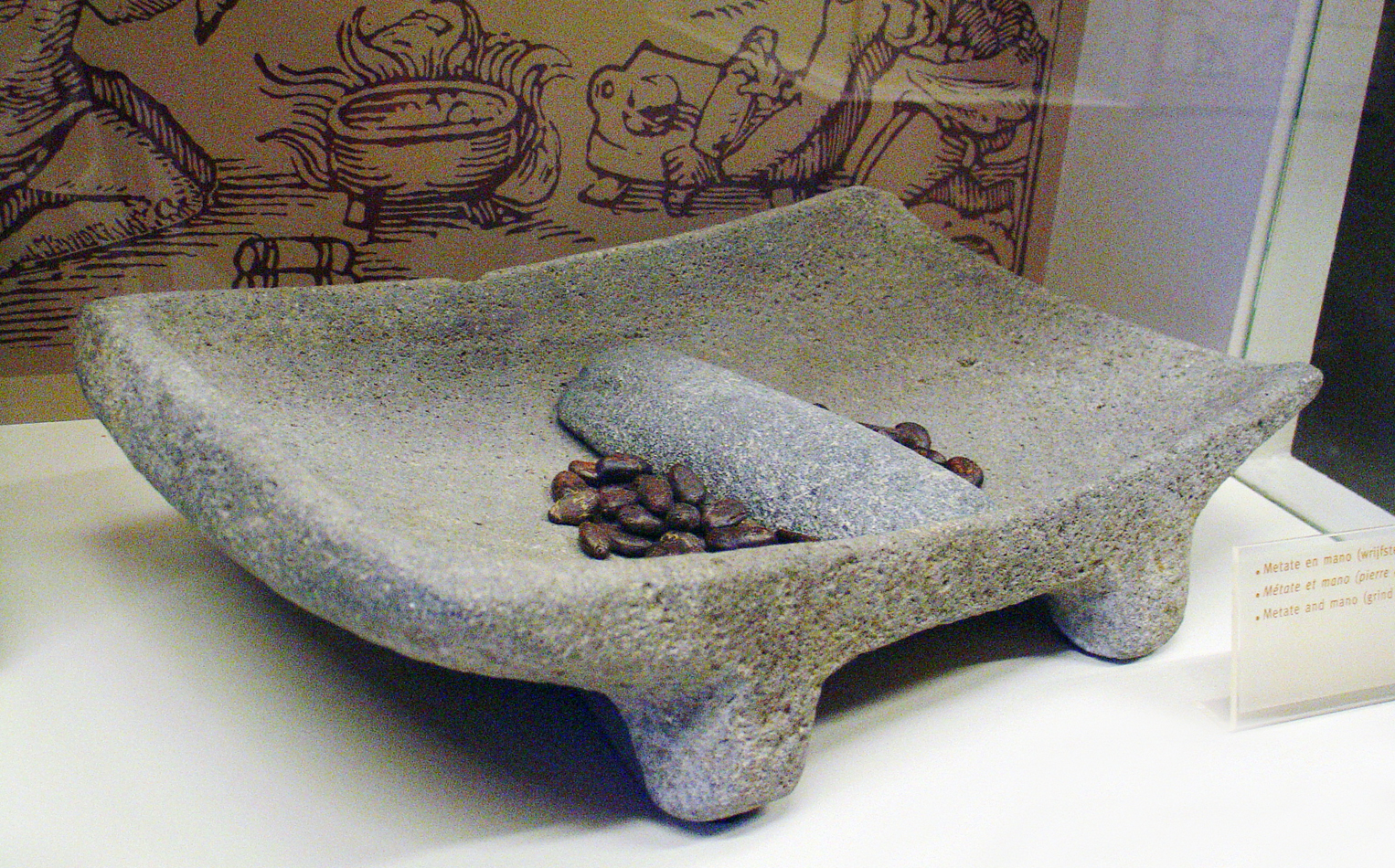 Ancient stone metate and mano used by Maya and Aztec civilizations to grind cacao beans