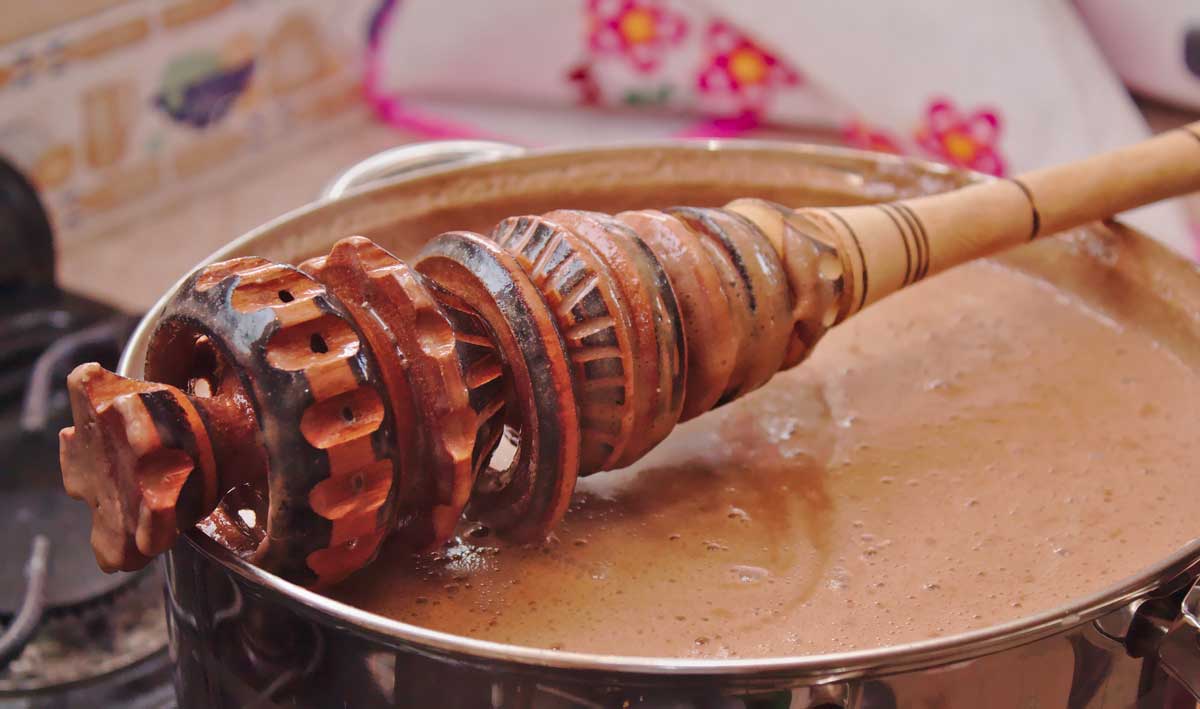 Hand-carved wooden molinillo whisk spun between the palms to froth cacao beverages